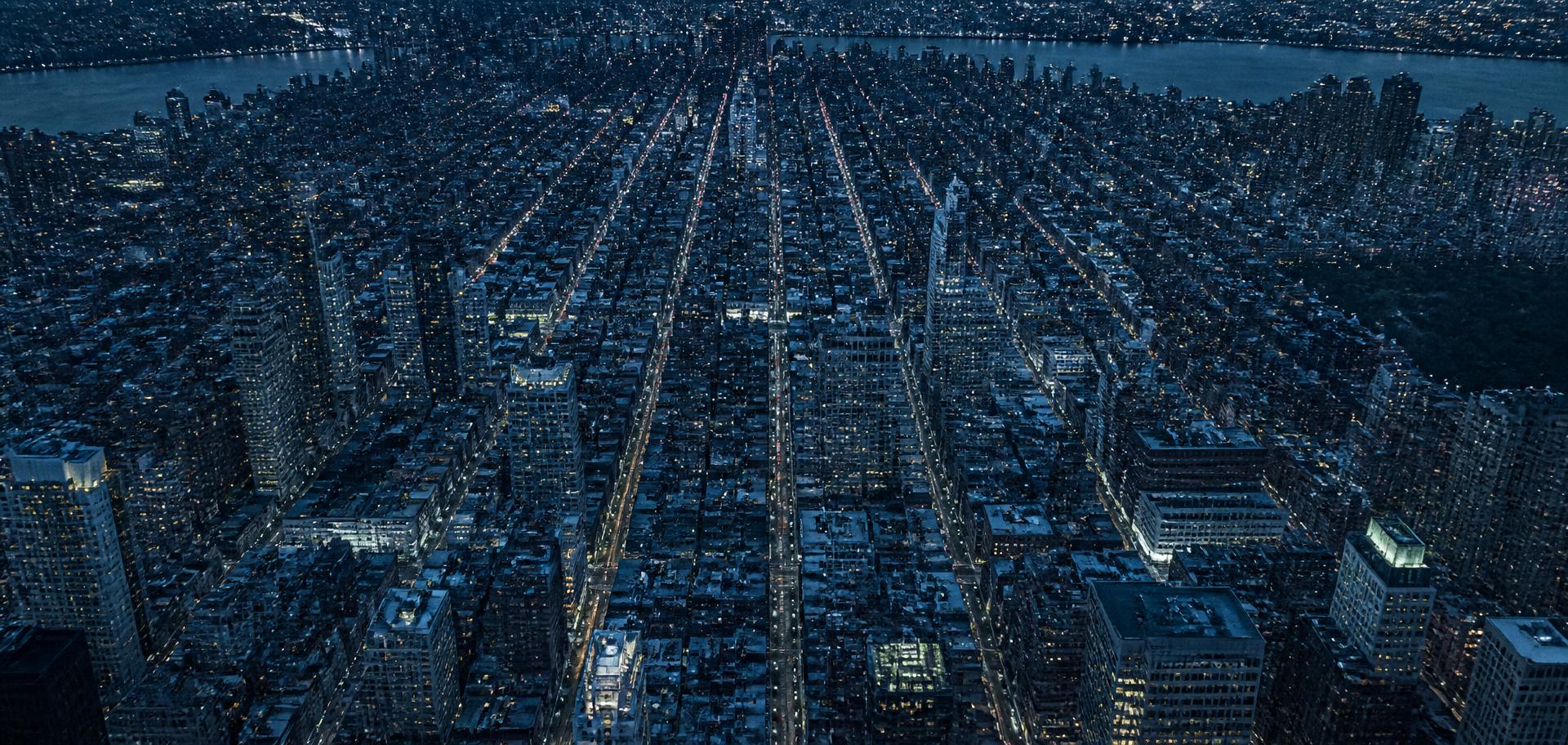 Aerial view of a dense city grid at blue hour